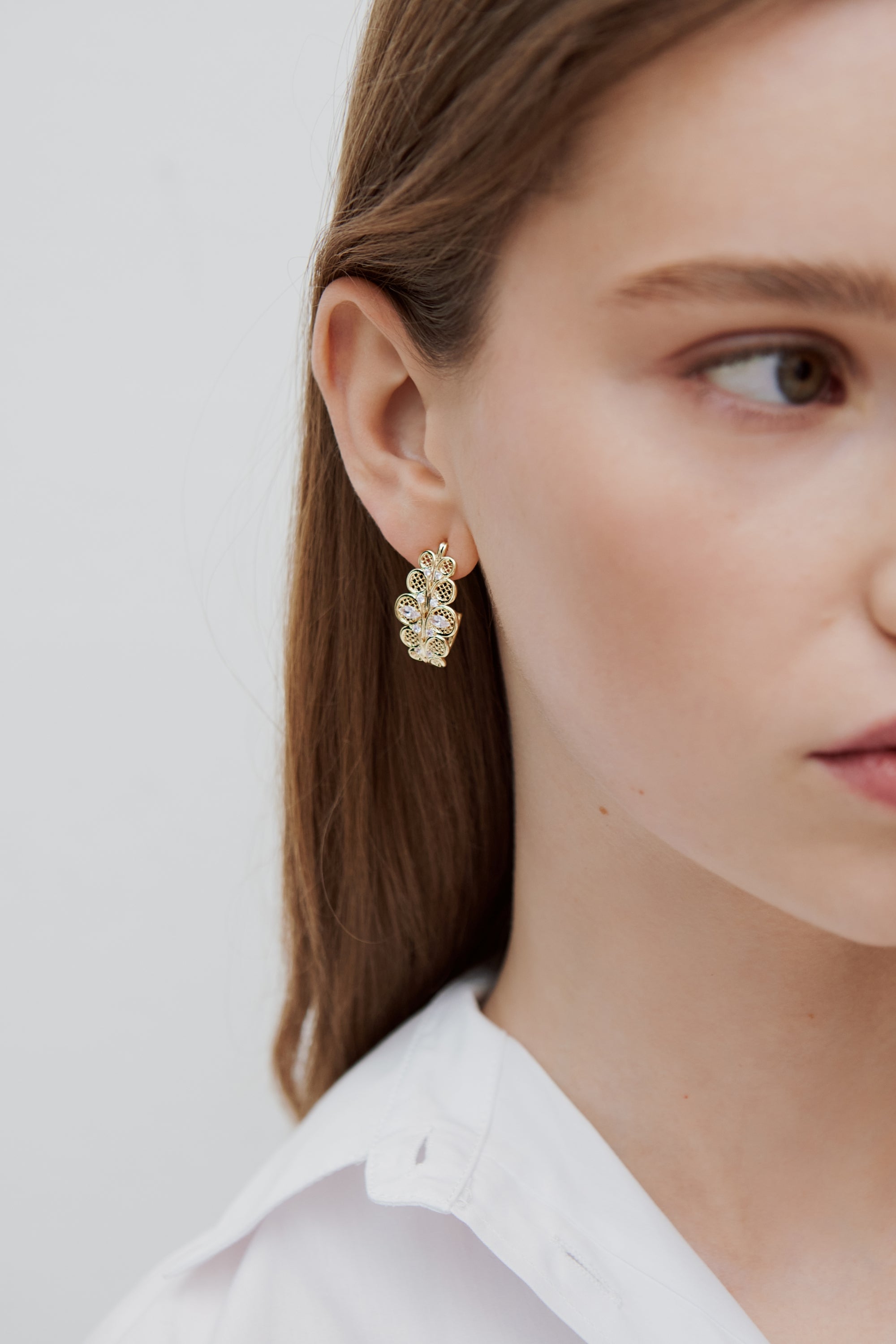 Golden filigree hoop earrings with crystals