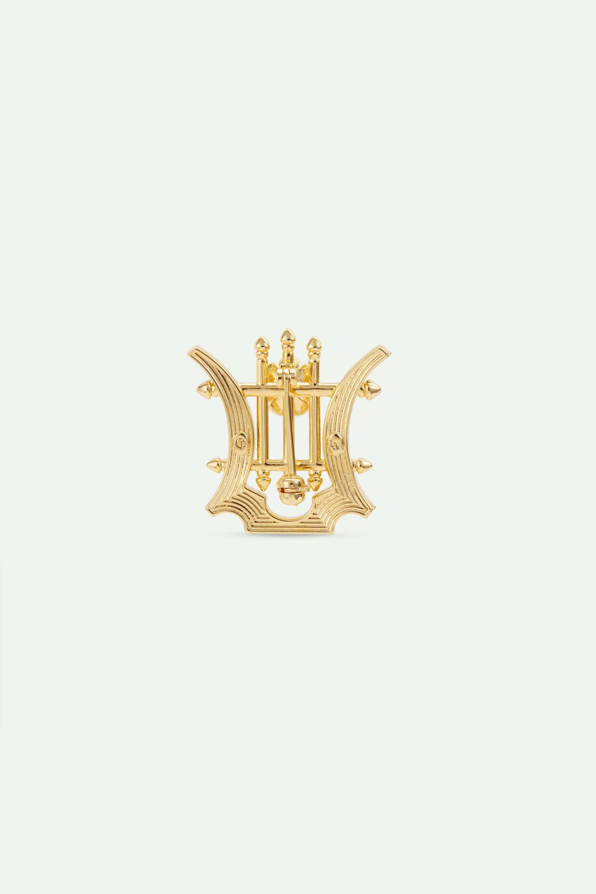 Golden lyre brooch with crystals