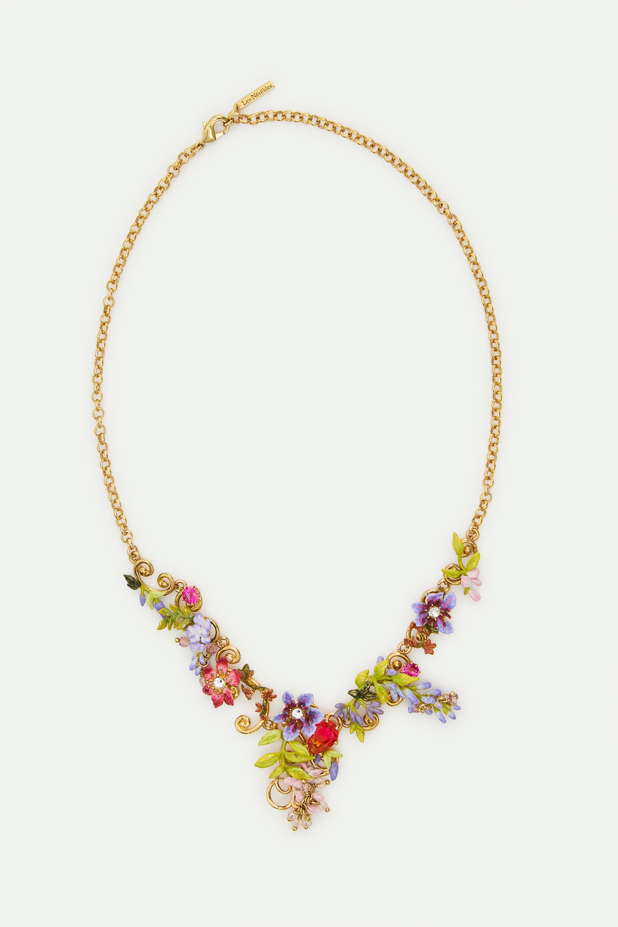 Statement necklace with pink and purple wisteria on a golden arabesque, adorned with ivy and dangling faceted pink crystal beads
