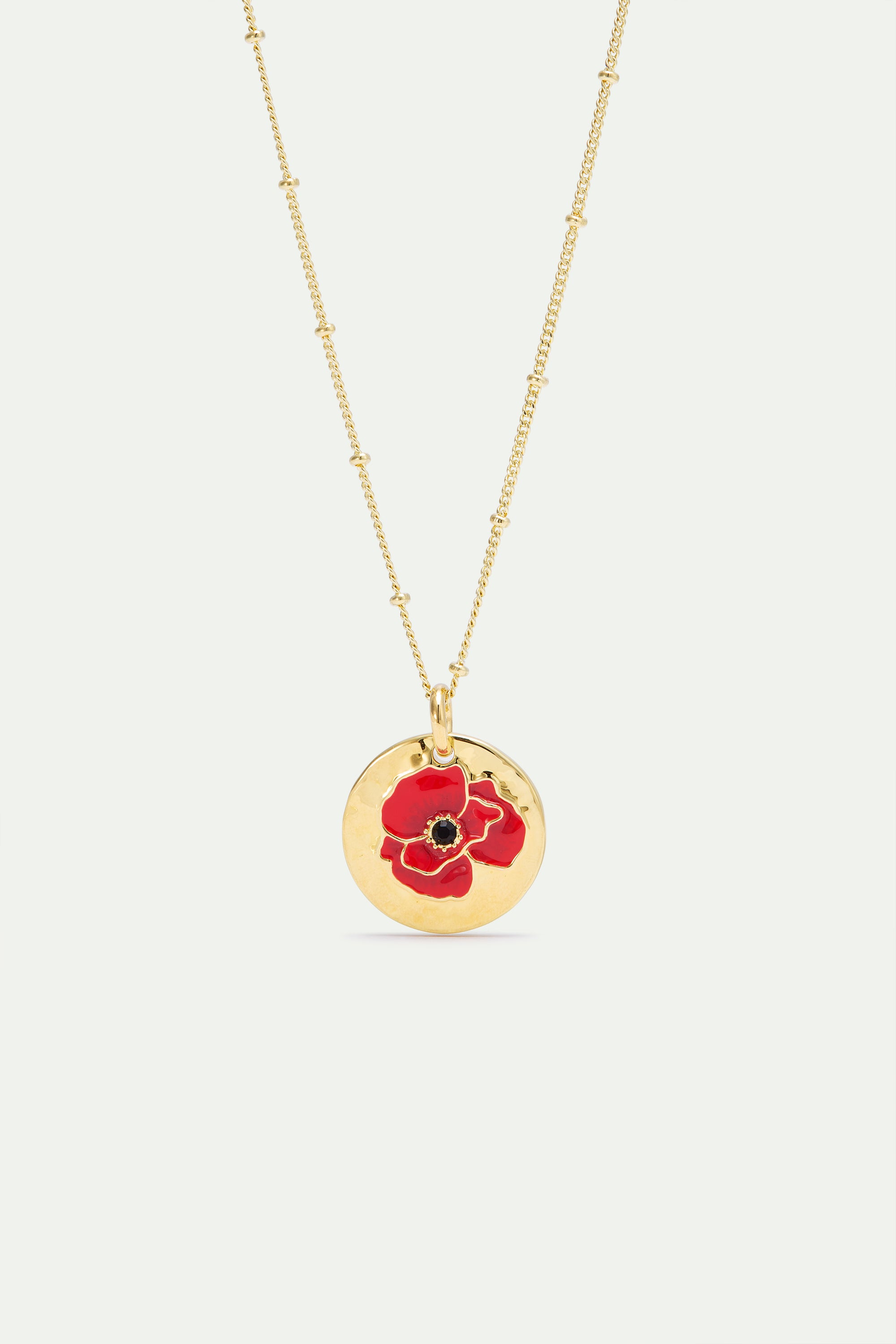 Pendant necklace with poppy on gold medallion