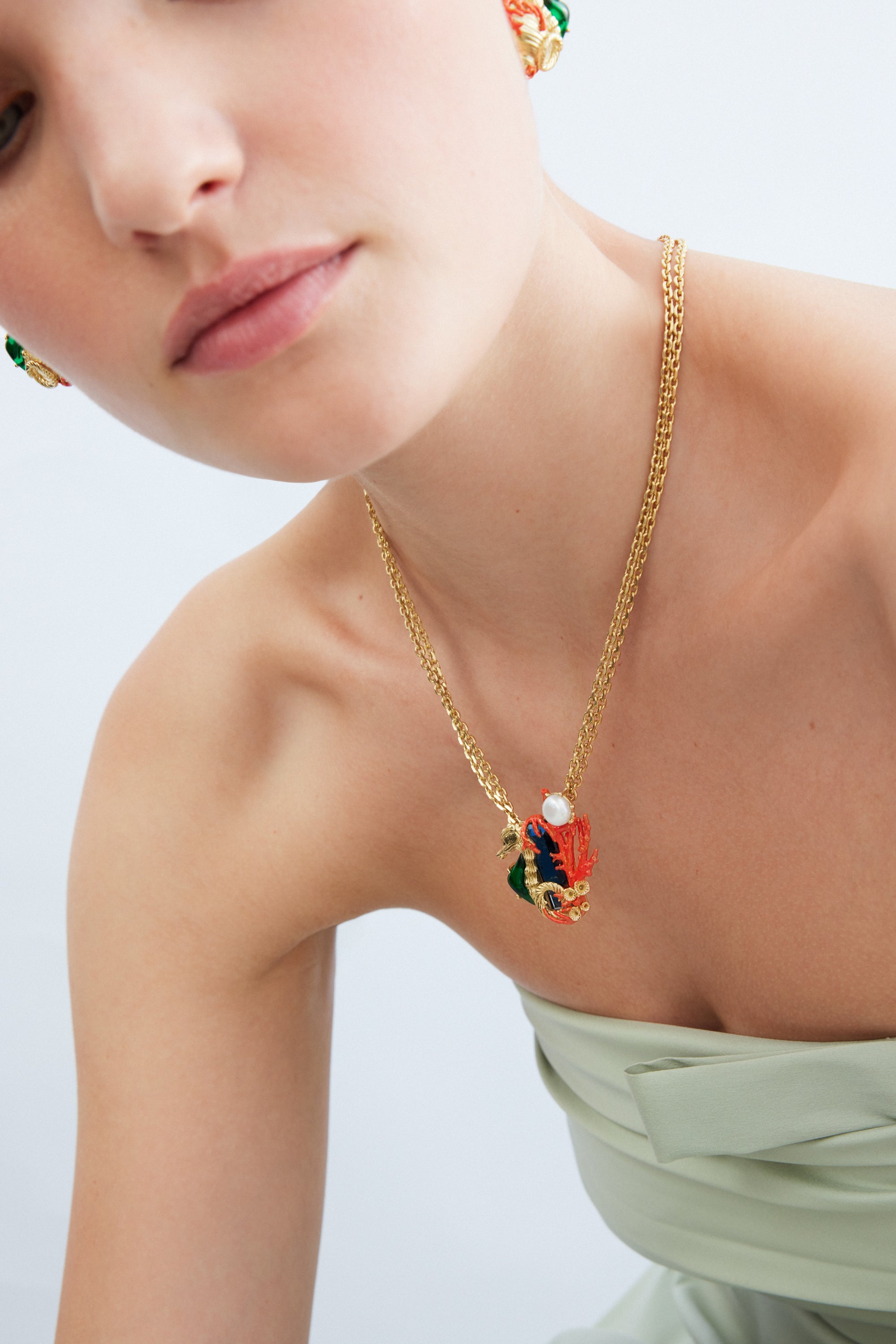 Navy blue stone necklace with green and golden seahorse