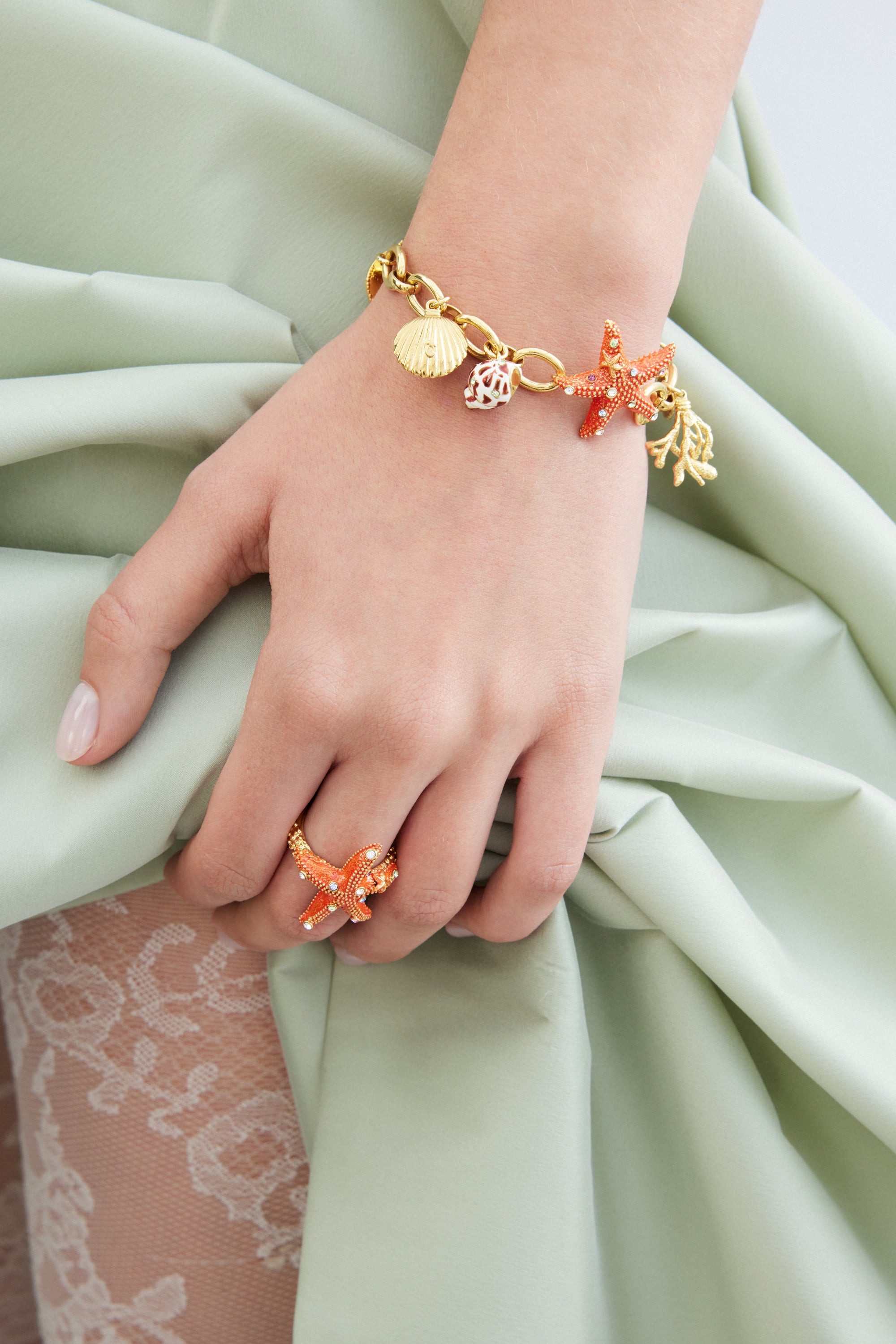 Adjustable orange starfish ring with multicoloured crystals