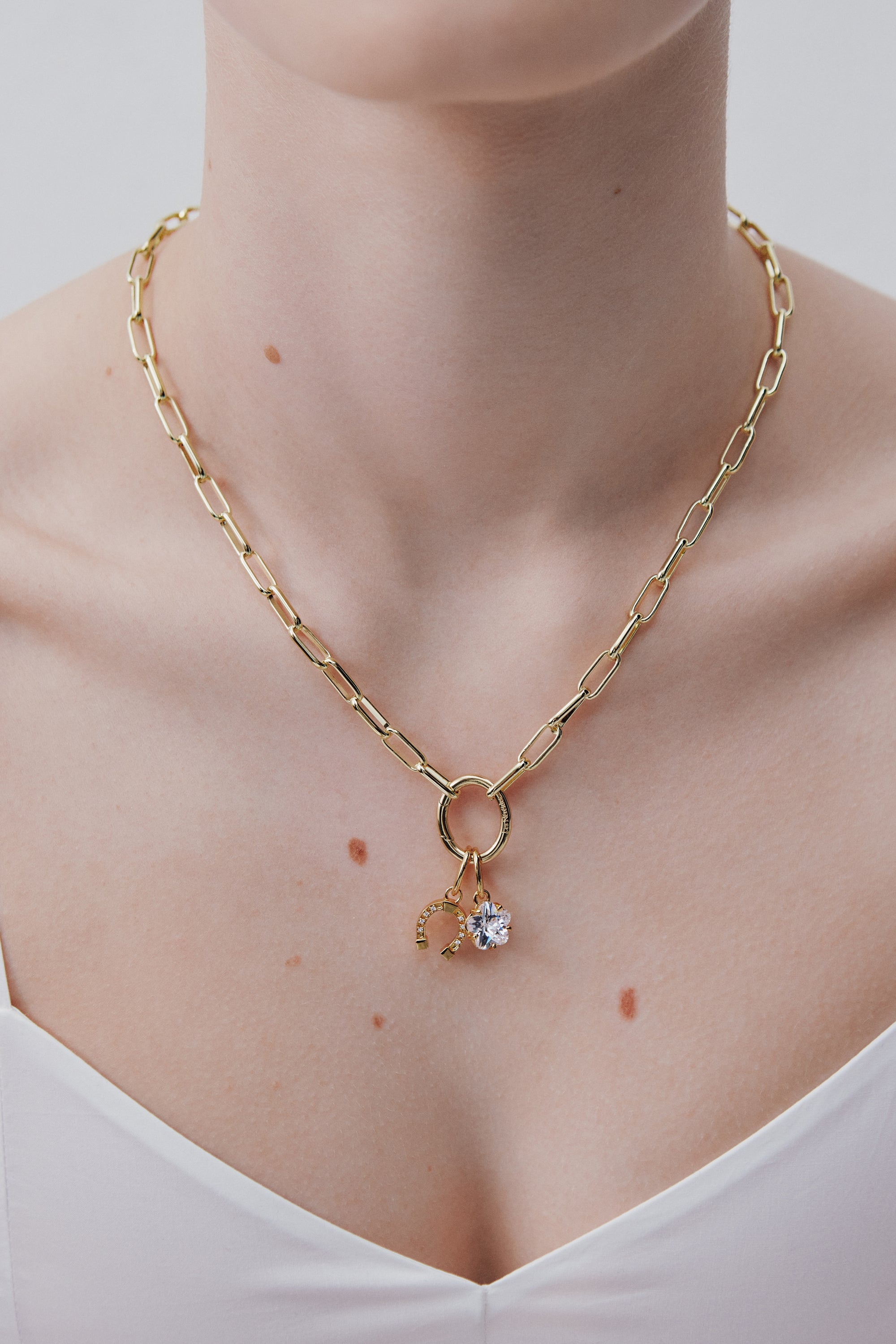 Gold-plated horseshoe pendant, Conjuring and Abnegation
