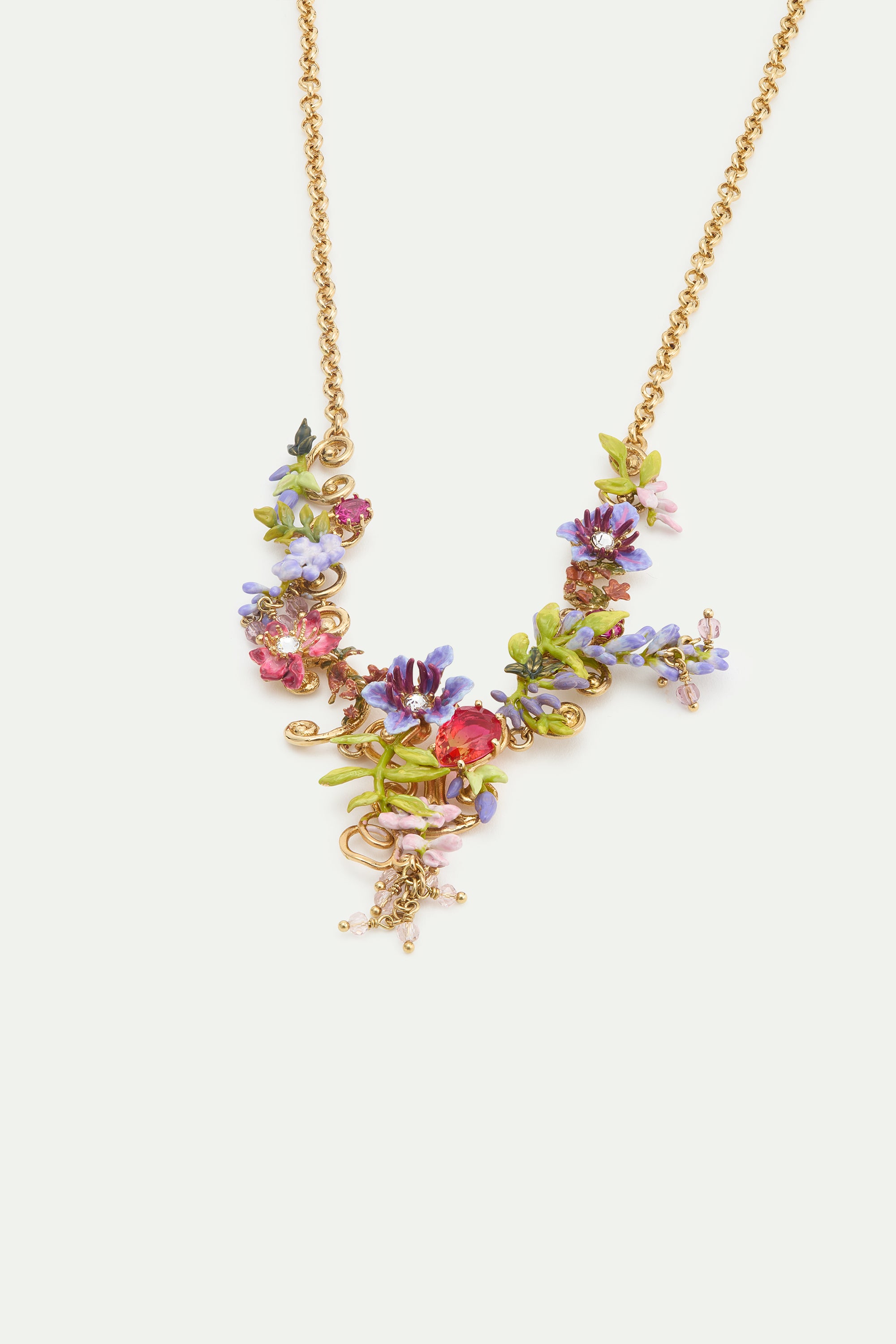 Statement necklace with pink and purple wisteria on a golden arabesque, adorned with ivy and dangling faceted pink crystal beads