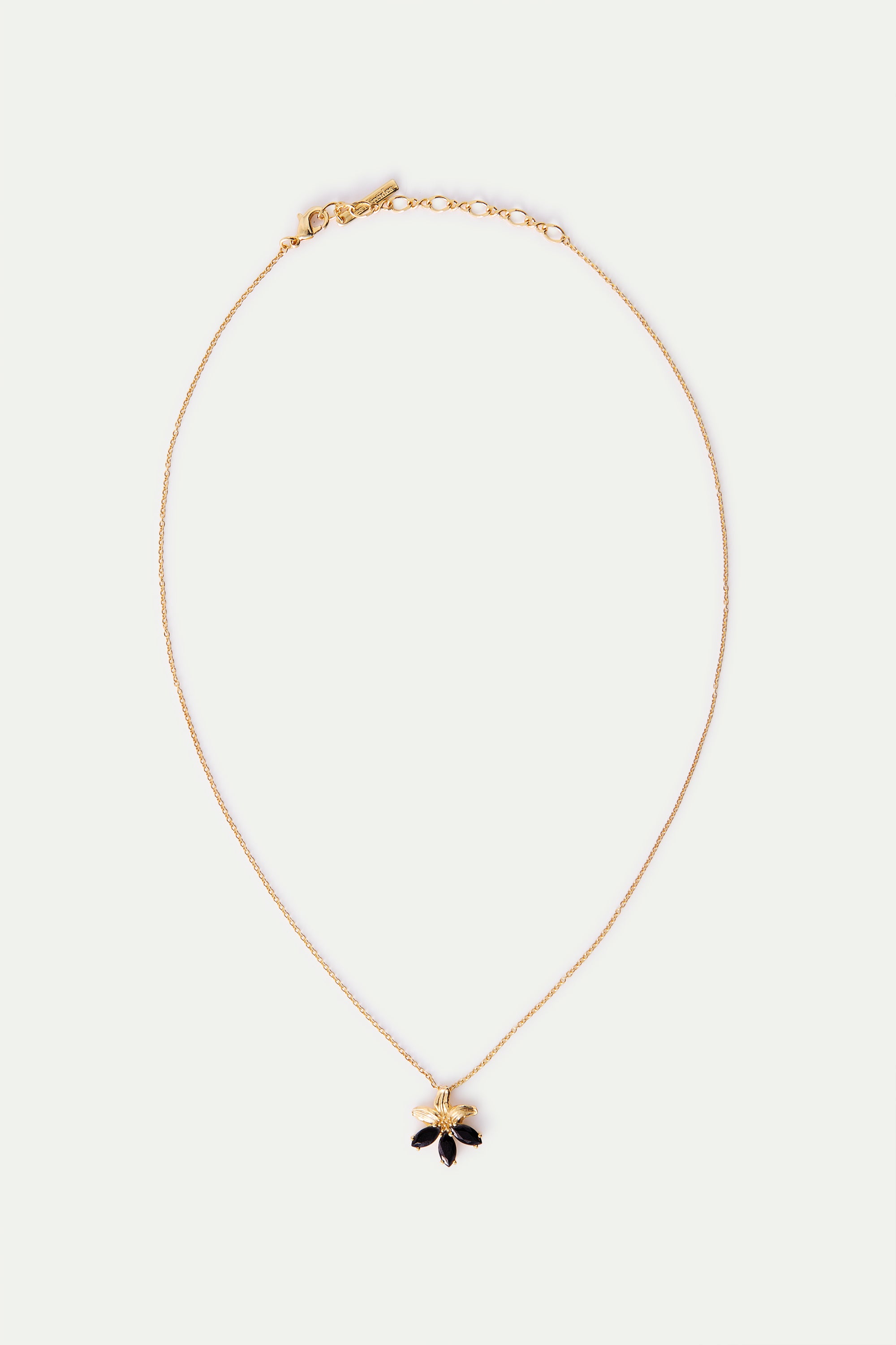 Gold lily and black stone pendant necklace