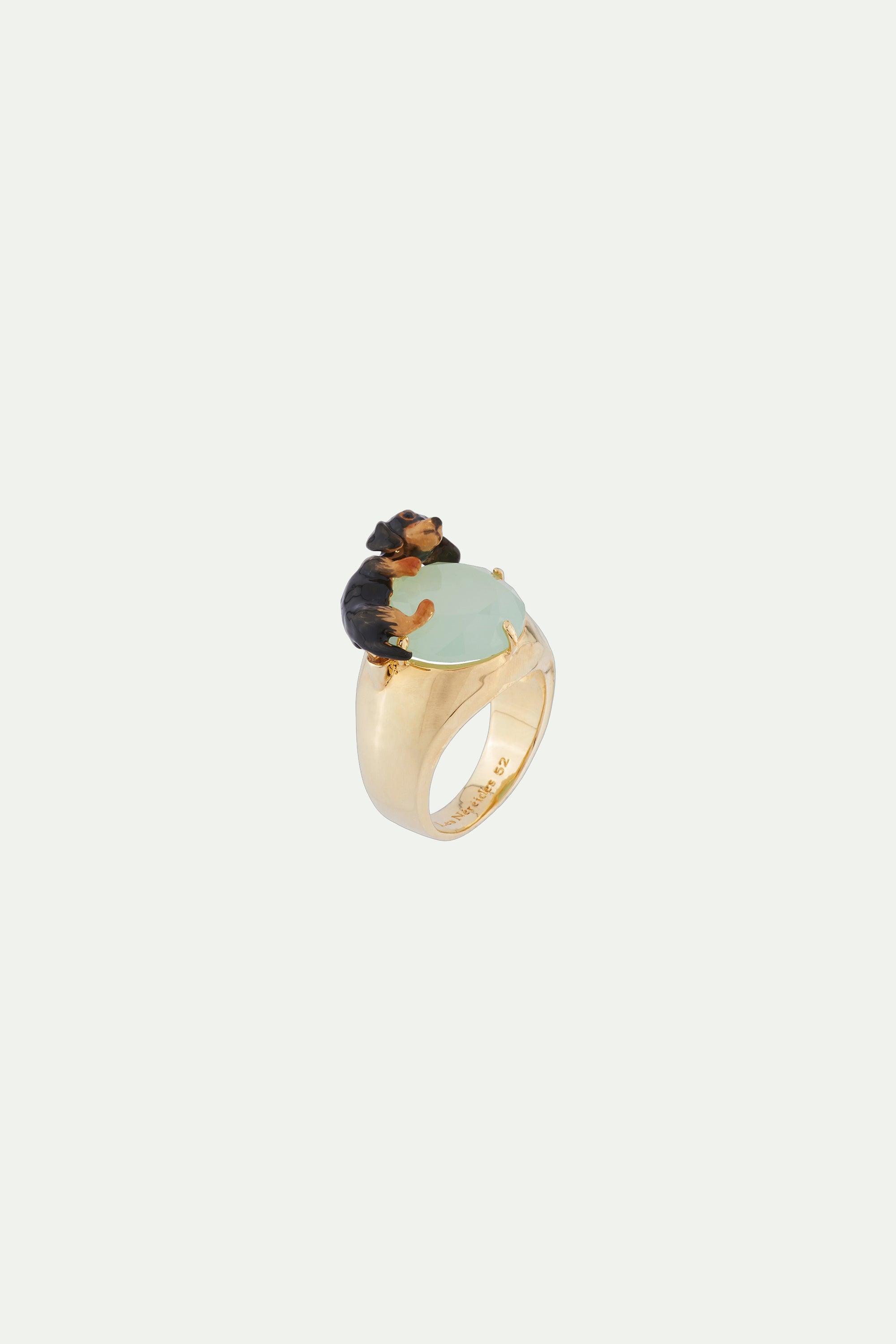 Ring with small dachshund lying on faceted crystal