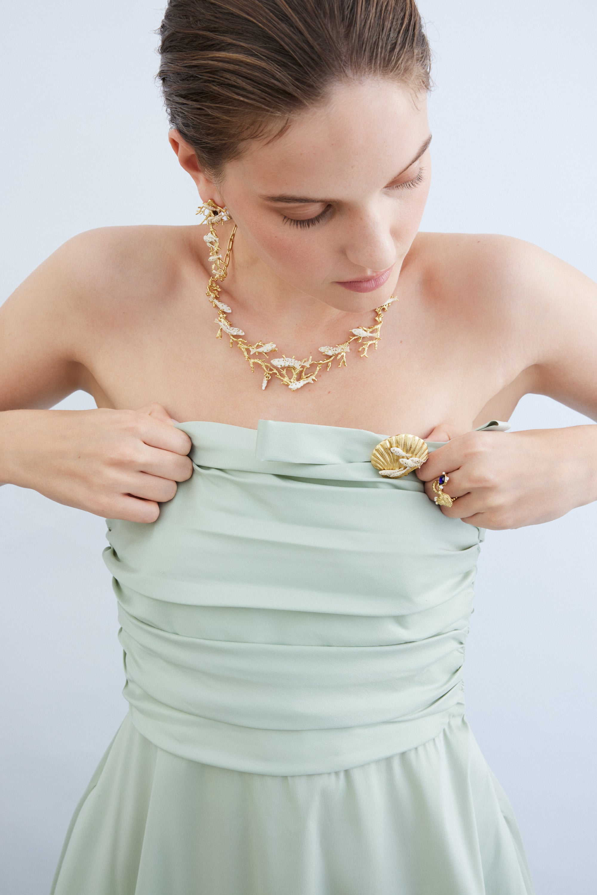 Golden seashell and white fish brooch