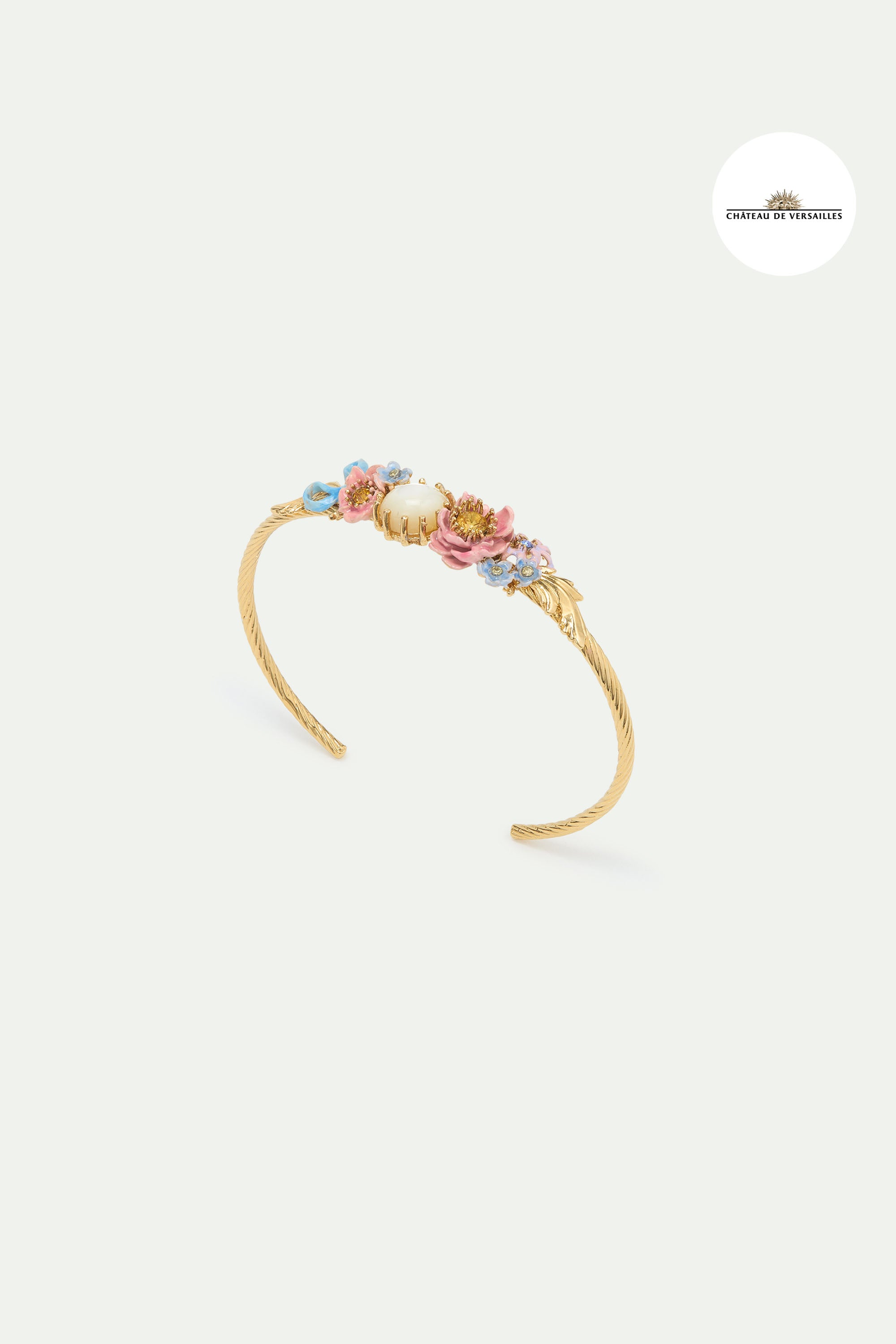 Bangle bracelet adorned with pink and blue flower and mother of pearl round stone