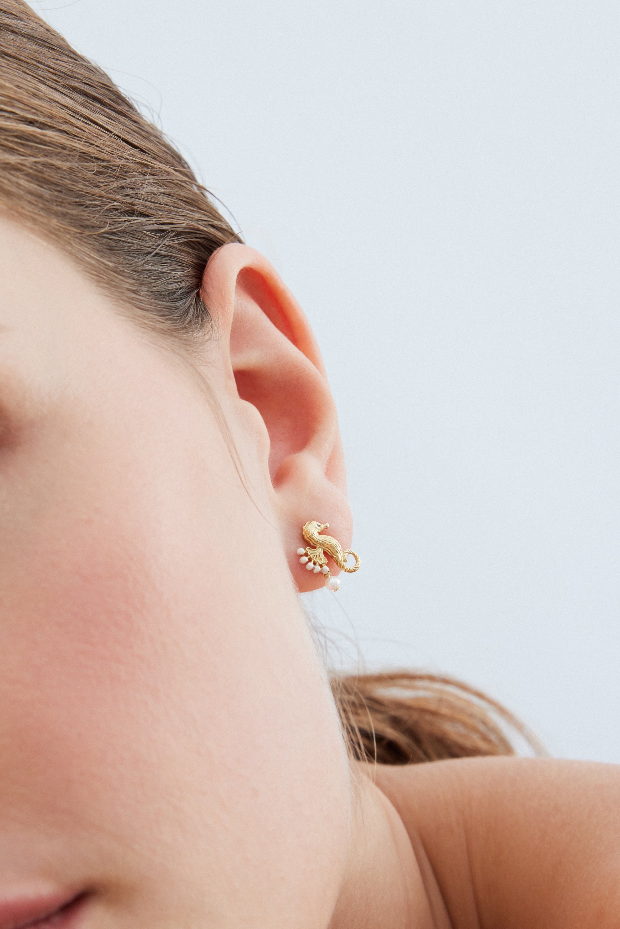 Golden seahorse and white pearl earrings
