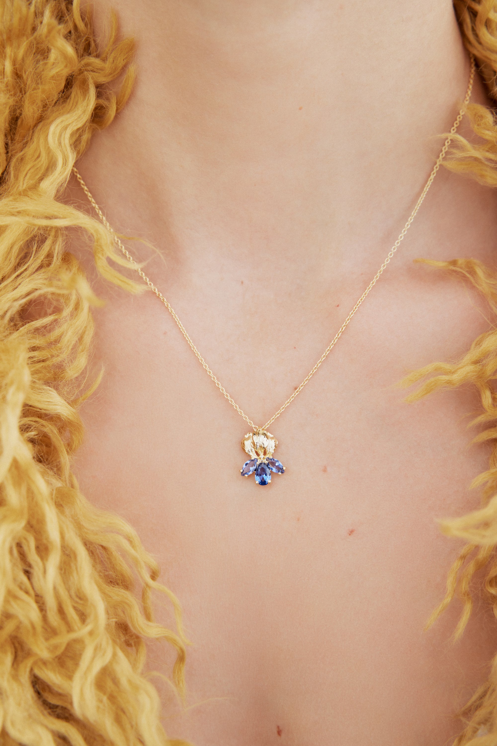 Gold iris flower and blue stone pendant necklace