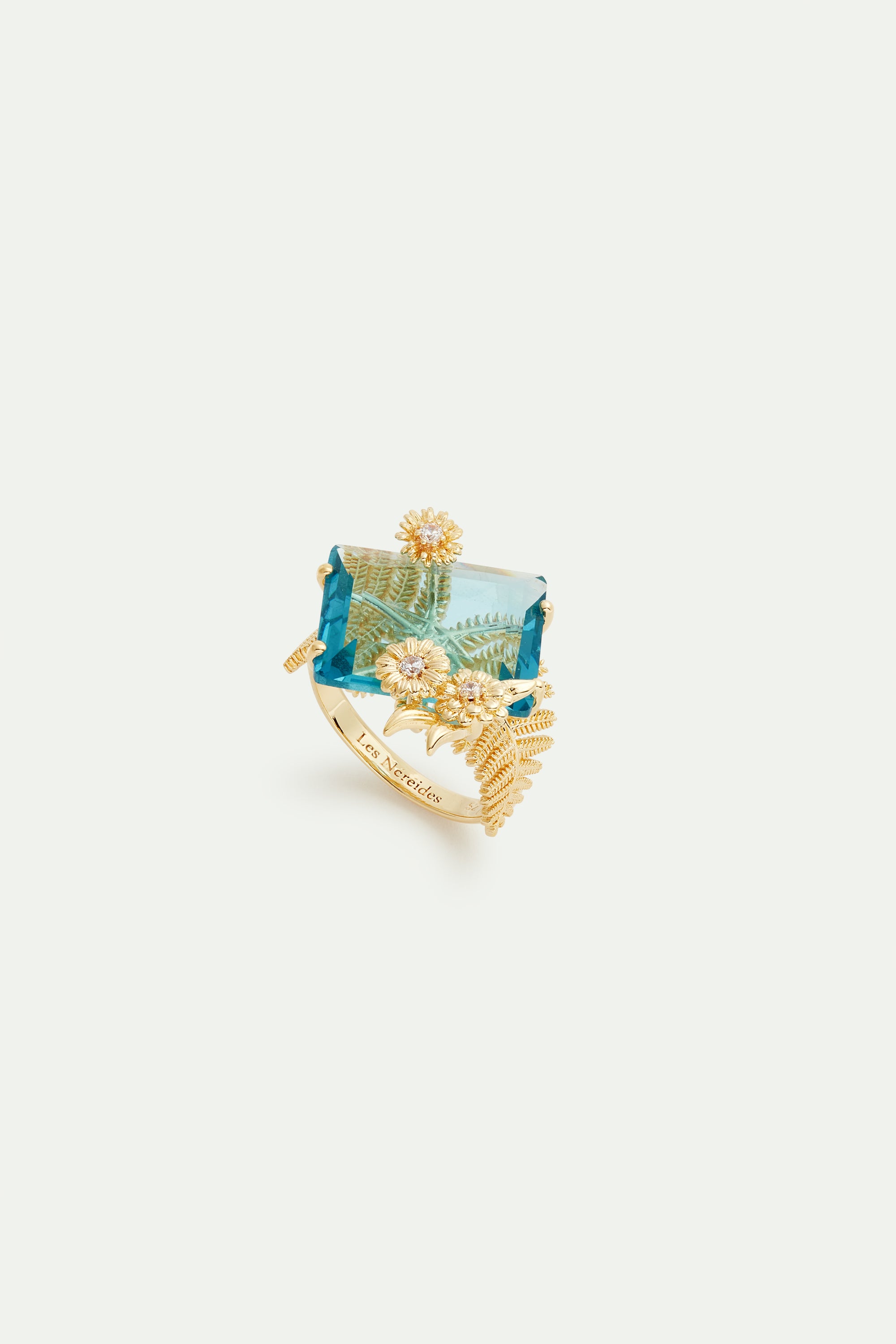 Blue cut stone and golden flower ring