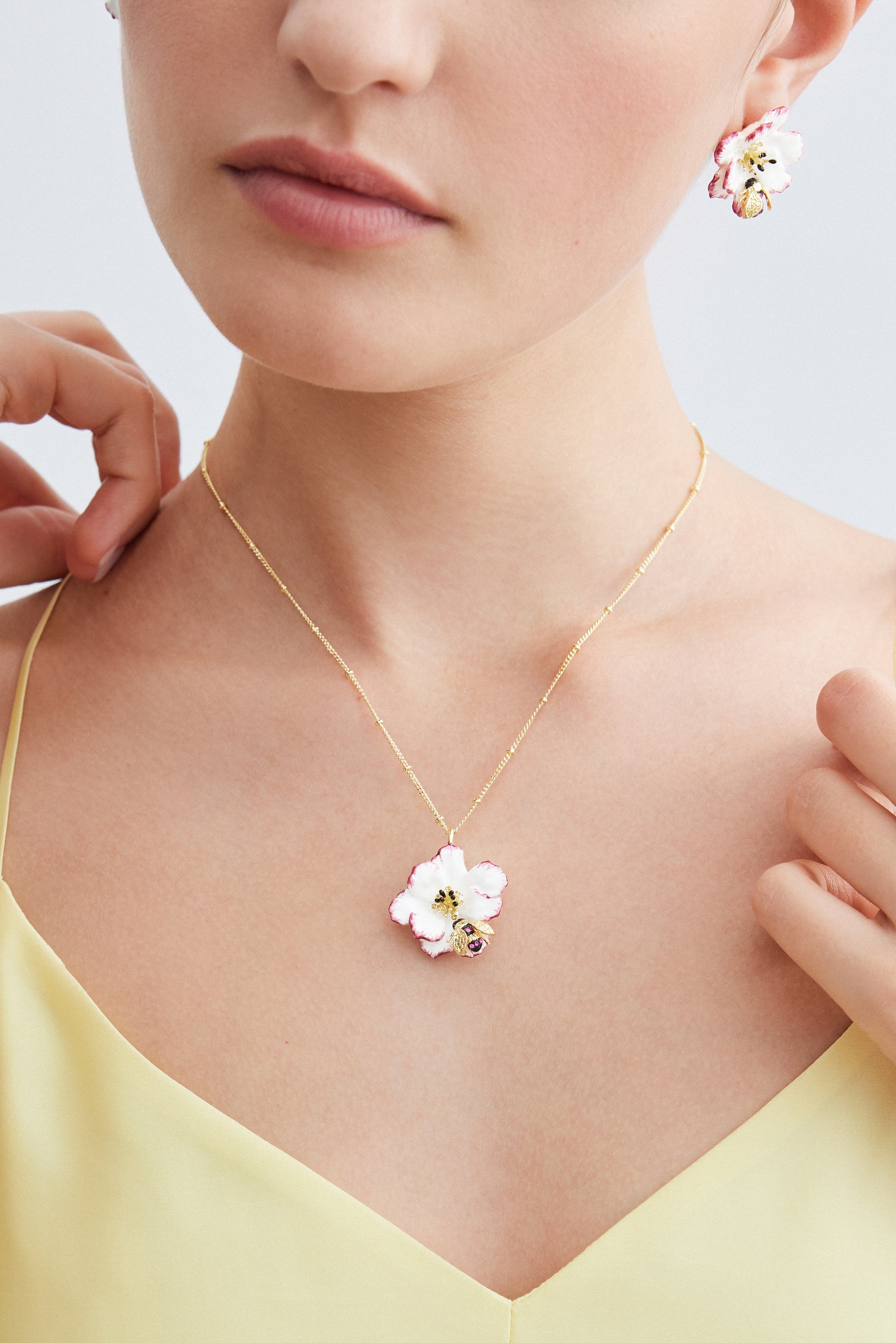 Pendant necklace with white and pink cosmos flower and gold bee