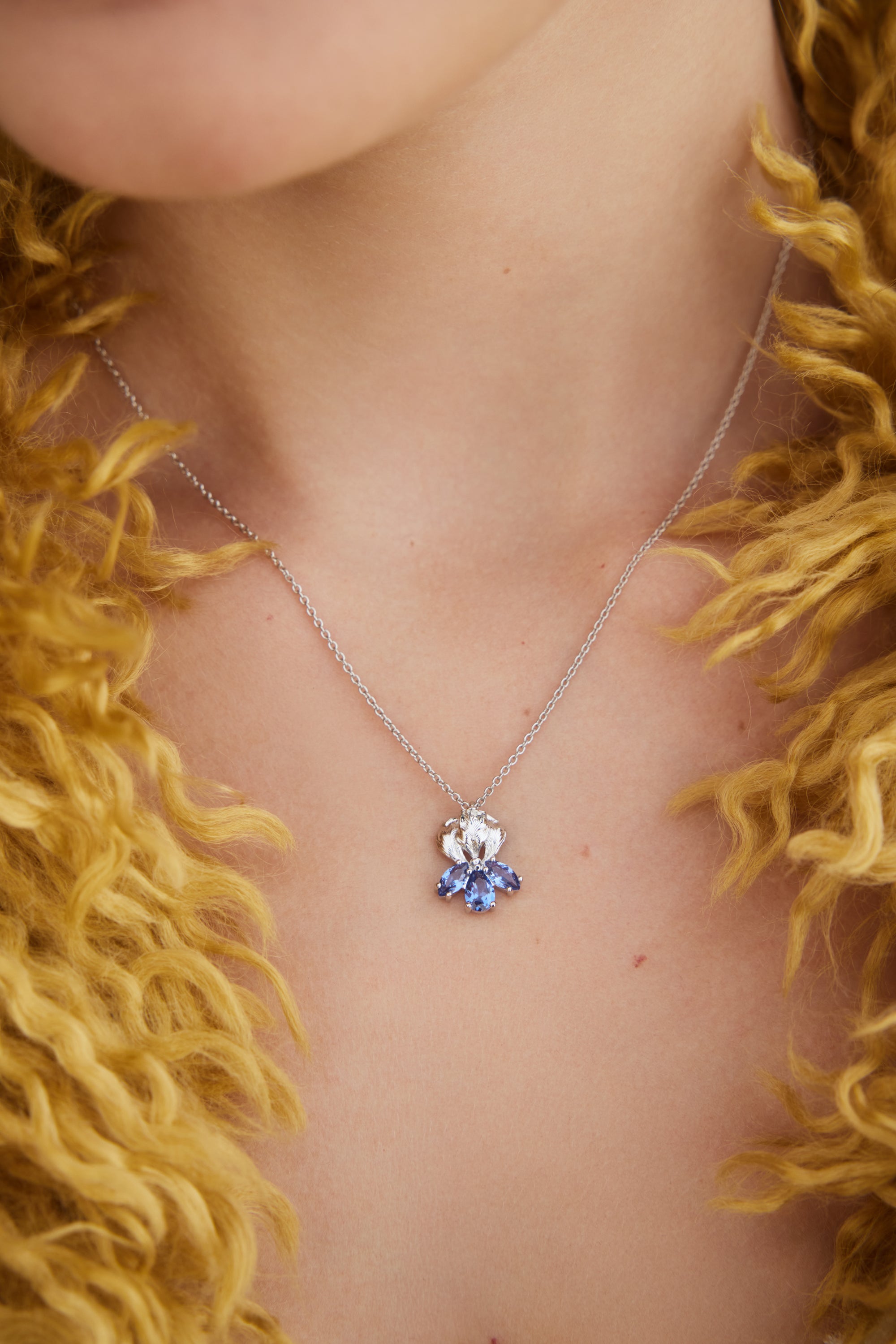 Silver iris flower and blue stone pendant necklace