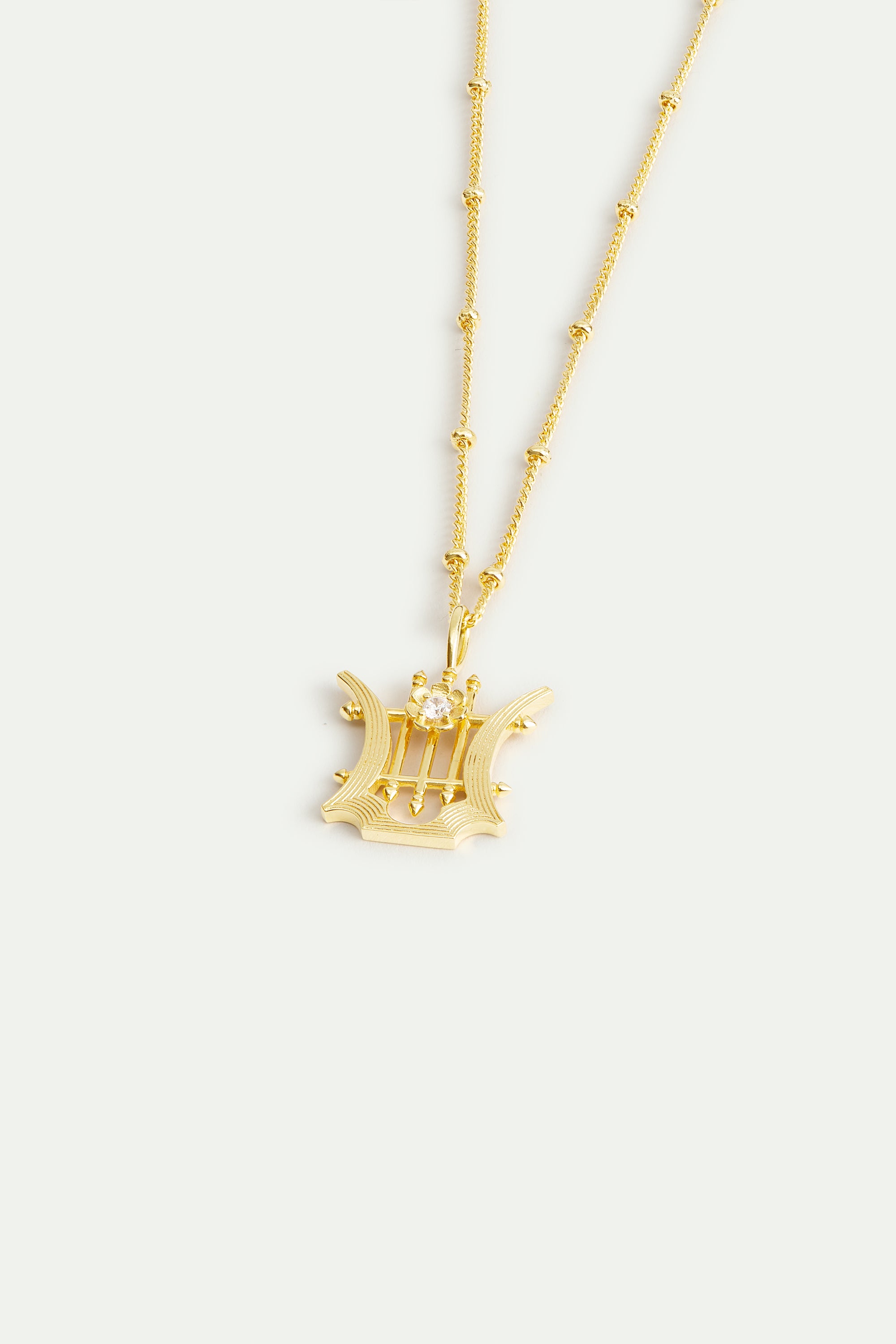 Golden lyre pendant necklace