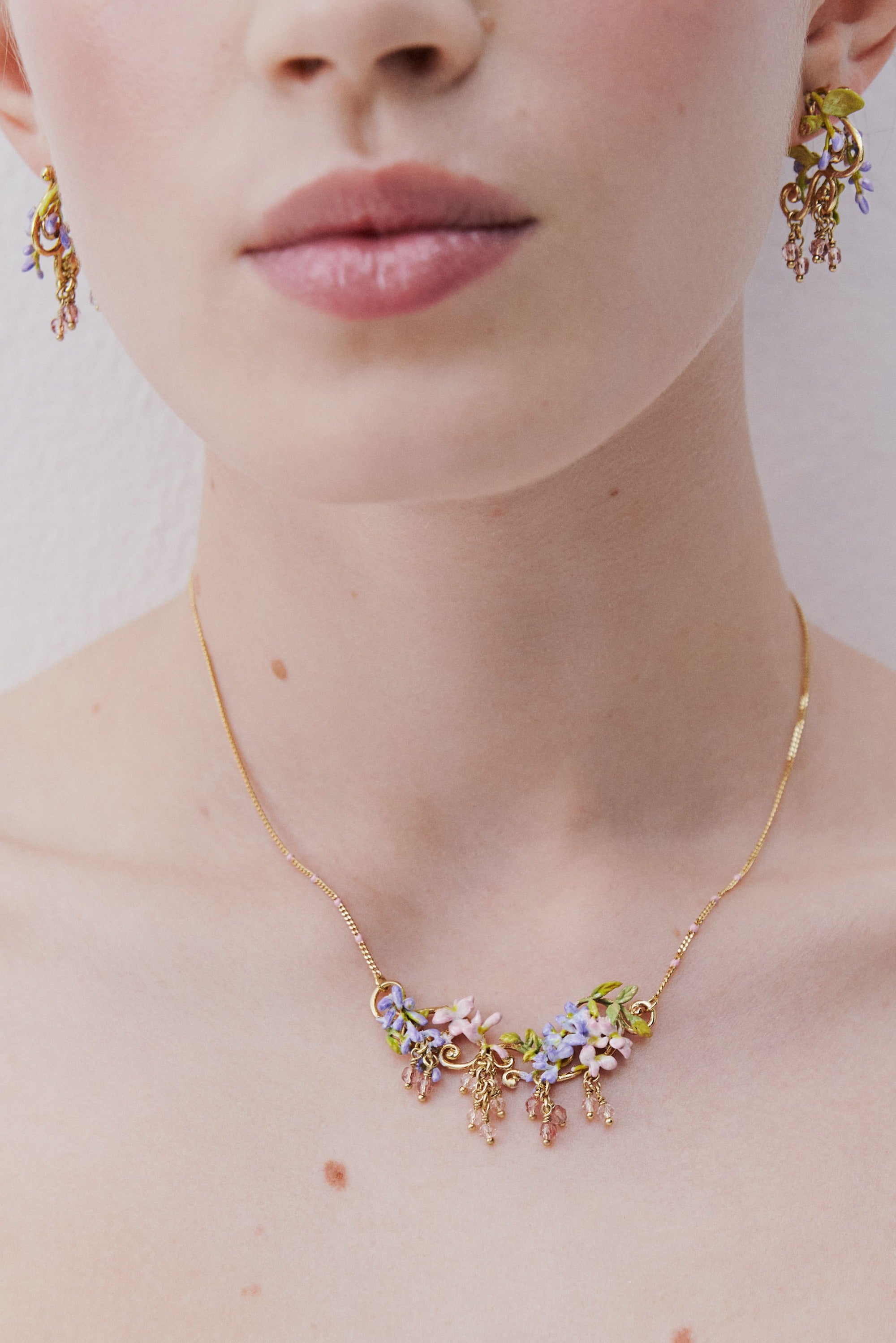 Purple wisteria post earrings on golden arabesque, ivy and faceted crystal beads