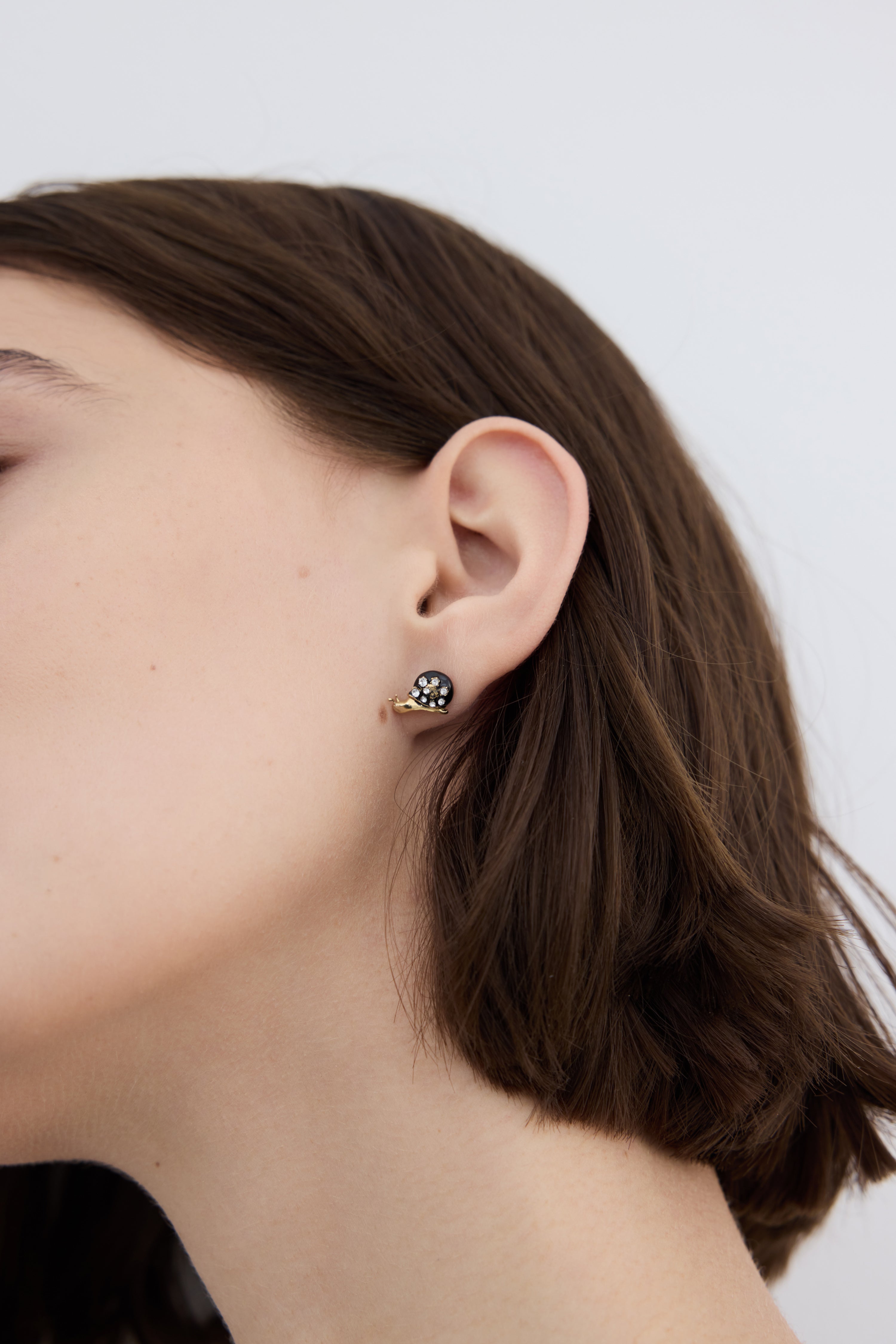 Black and gold snail post earrings with crystals