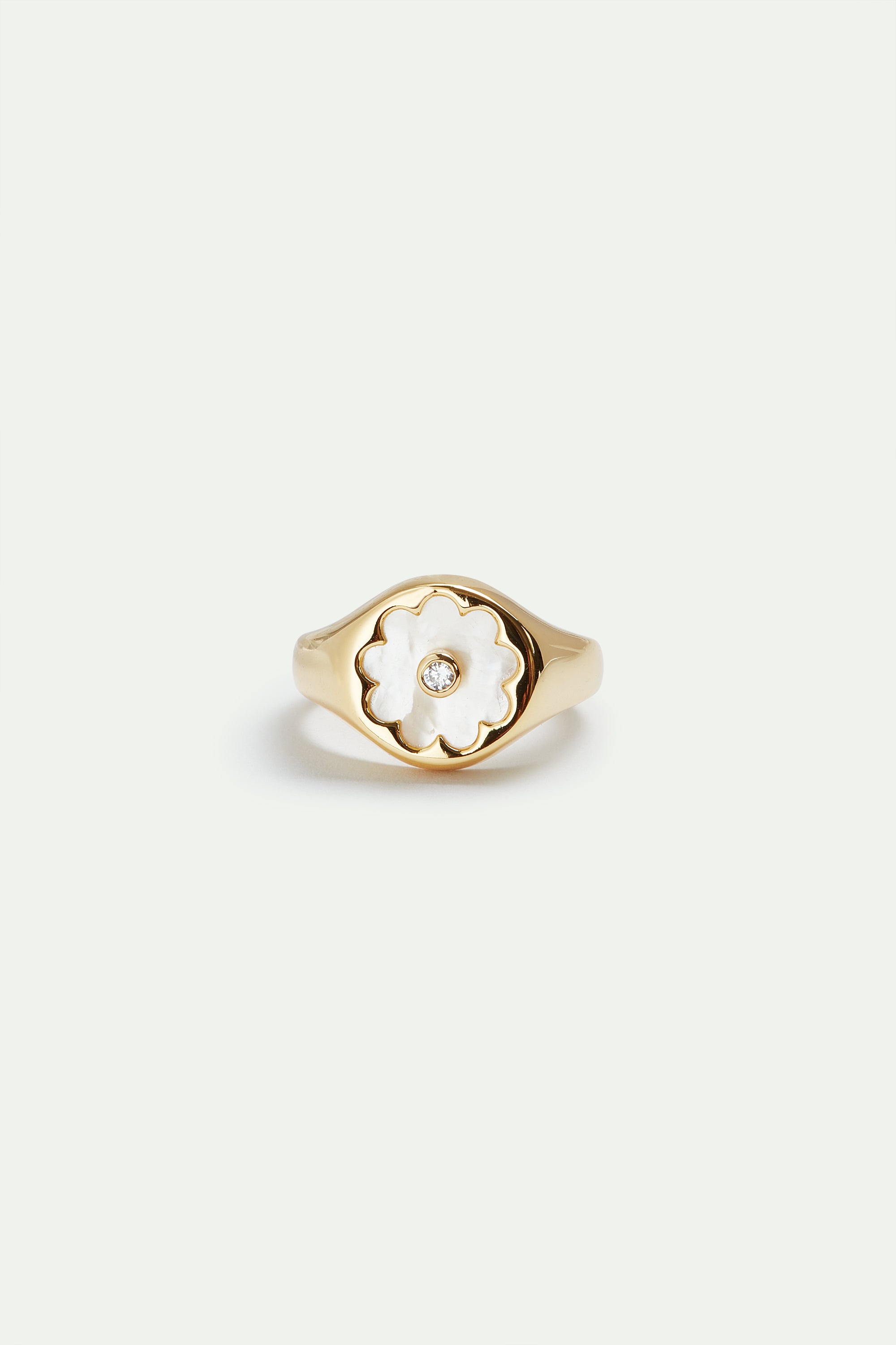 Golden ring with mother of pearl white flower