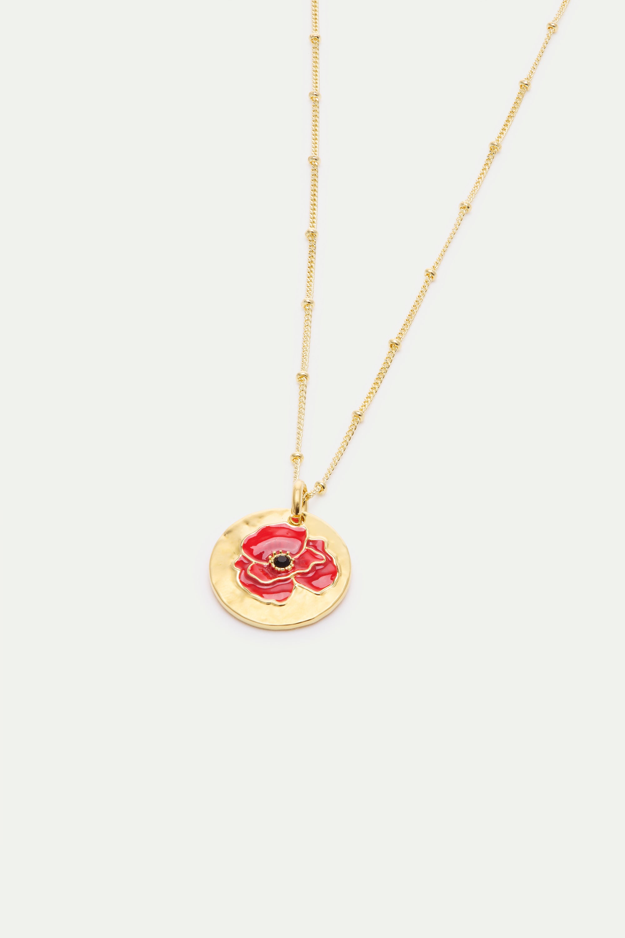Pendant necklace with poppy on gold medallion