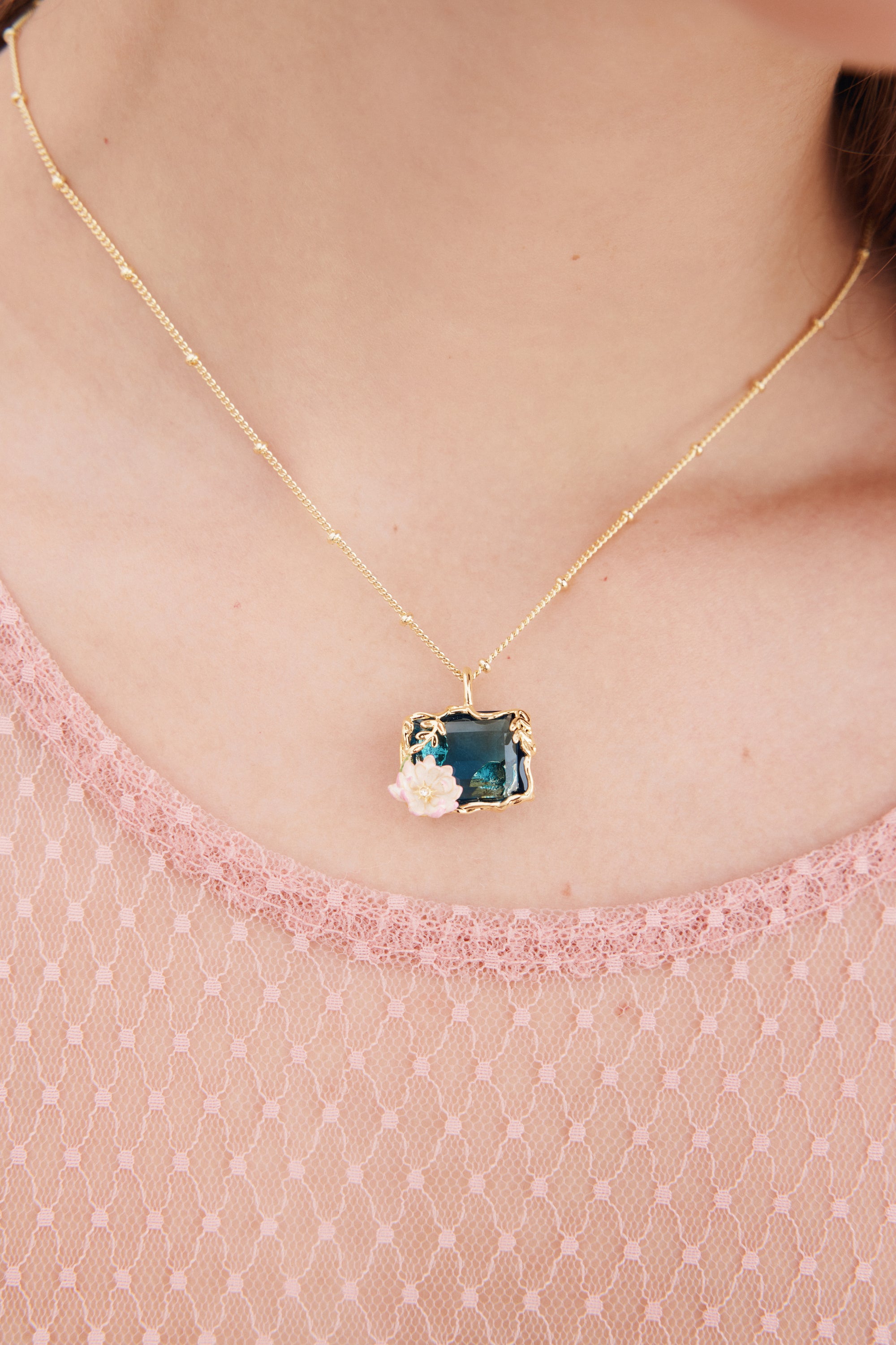 Necklace with blue and pink water lily pendant