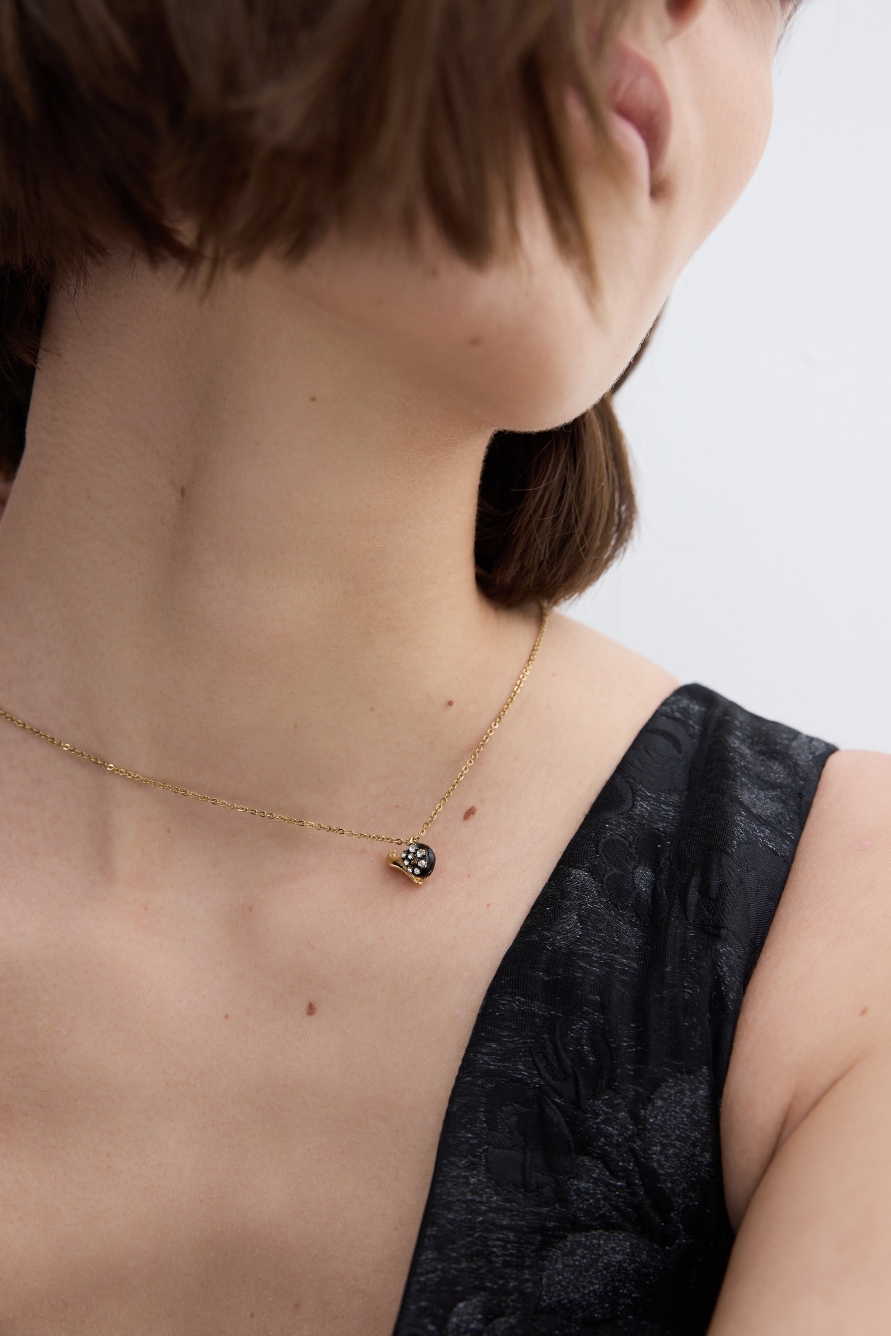 Black and gold snail pendant necklace with crystals