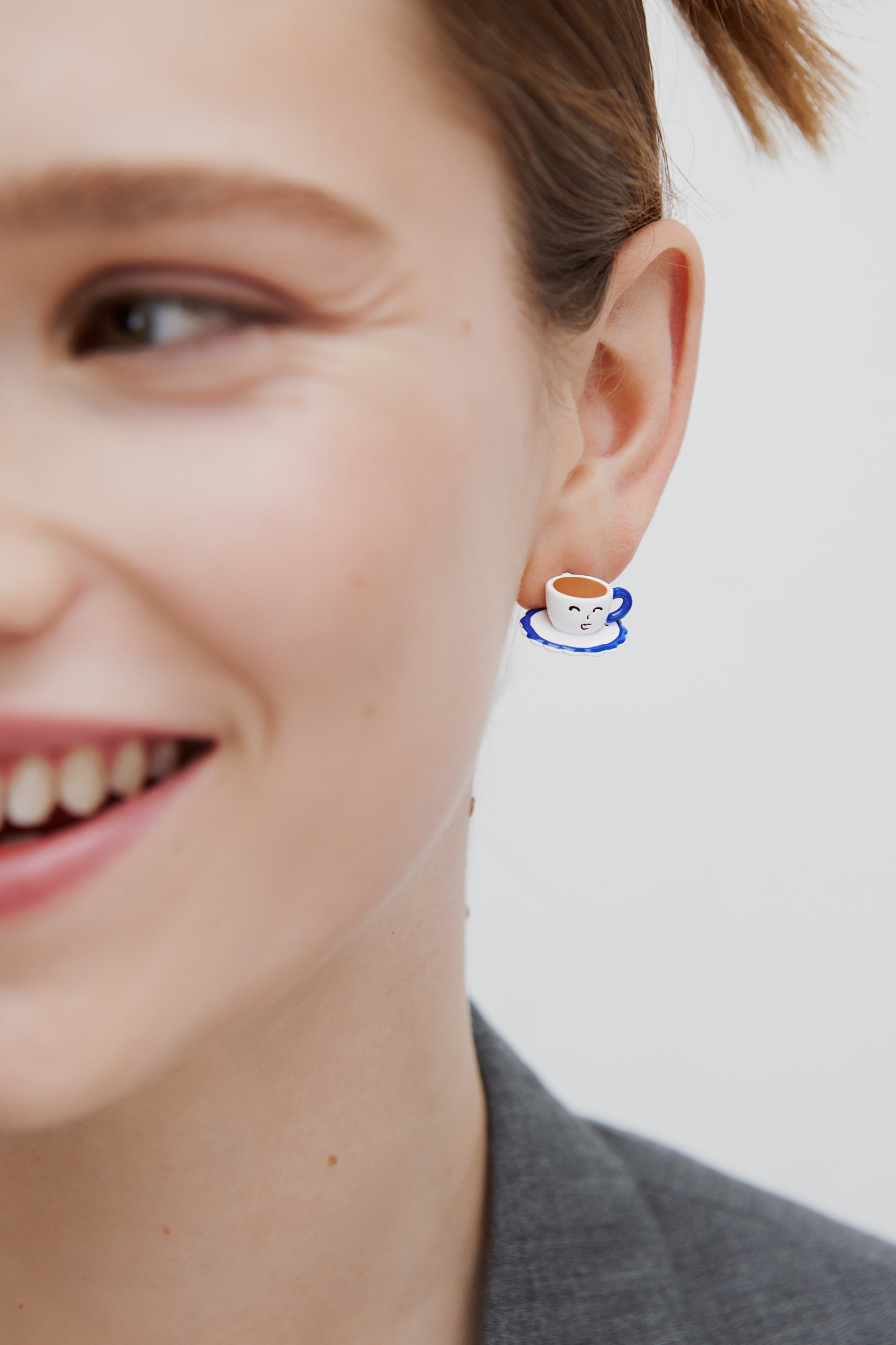 Asymmetric post earrings with blue and white teapot and little yellow stone